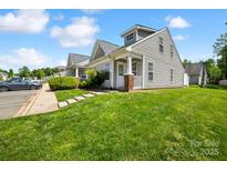 View of the exterior of a well-manicured townhome with a green lawn and sidewalk at 3219 Cottage Rose Ln, Rock Hill, SC 29732