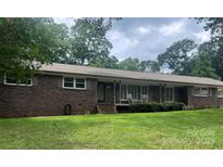 Inviting brick home with a well-manicured lawn and a welcoming front porch, ideal for curb appeal at 3378 Tanglewood Dr, Rock Hill, SC 29732