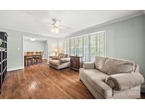 Bright living room featuring hardwood floors, neutral paint, and large windows with plantation shutters at 3378 Tanglewood Dr, Rock Hill, SC 29732