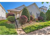 Charming home with manicured front yard, lush landscaping, and inviting entrance steps at 3939 Archer Notch Ln, Huntersville, NC 28078
