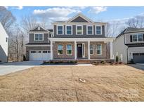 Beautiful two-story home with a two car garage and manicured front lawn at 5027 Mclaughlin Loop # 61, Waxhaw, NC 28173