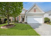 Charming home with a well-manicured lawn, two-car garage, and tasteful landscaping at 10314 Threatt Woods Dr, Charlotte, NC 28277