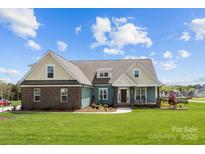 Charming two-story home with a manicured lawn and a mix of brick and siding exterior at 1050 Coppergate Dr, Salisbury, NC 28147