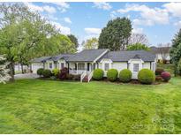 Charming single-story home features beautiful landscaping, a manicured lawn, and a welcoming front porch at 106 S Oakwood Dr, Kings Mountain, NC 28086