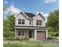 Charming two-story home boasts a shingle facade, attached garage, and professionally landscaped front yard at 1142 Forest Dr, Marshville, NC 28103