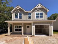 Charming new construction home with a light tan exterior and an attached garage at 1142 Forest Dr, Marshville, NC 28103