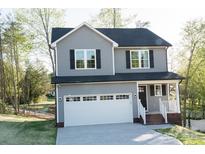 Charming two-story home featuring gray siding, a white garage door, and a covered front porch at 200 N Kayla Dr, Salisbury, NC 28146
