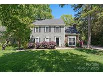 Charming two-story home featuring gray siding, black shutters, and a well-manicured lawn, creating a welcoming curb appeal at 2224 Clonmel Pl, Charlotte, NC 28262