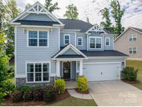 Charming two-story home with a well-manicured lawn and welcoming front porch at 3017 Winged Teal Ct, Belmont, NC 28012