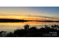Breathtaking sunset view overlooking the tranquil waterfront, creating a serene and picturesque setting at 31009 Executive Pt, Tega Cay, SC 29708