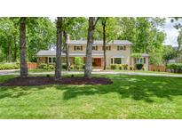 Charming two-story home with mature trees, stone accents, shutters, and a manicured lawn at 323 Richmond Rd, Salisbury, NC 28144