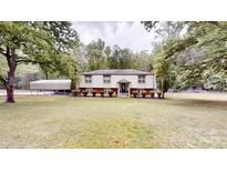 Charming split-level home with manicured lawn and convenient covered parking at 3816 Redman Rd, Shelby, NC 28150