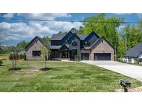 Stunning two-story home showcasing modern design, lush lawn, and a spacious driveway at 4377 Kiser Island Rd, Terrell, NC 28682