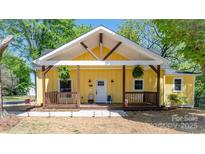 Inviting yellow home featuring a charming porch and crisp white trim details at 530 W Franklin St, Salisbury, NC 28144
