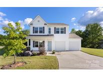 Charming two-story home with a welcoming front porch and a spacious two car garage at 548 Dutch White Dr, Clover, SC 29710