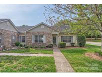 Charming single-story home featuring a brick facade, well-maintained lawn, and inviting walkway at 5604 Bradford Lake Ln, Charlotte, NC 28269
