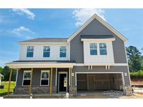 New two-story home featuring gray siding and a two-car garage at 1004 Rocking Horse Rd, Indian Trail, NC 28079