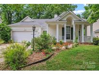 Charming single-Gathering home with a manicured front lawn, beautiful landscaping and covered porch at 11913 Little Stoney Ct, Charlotte, NC 28269