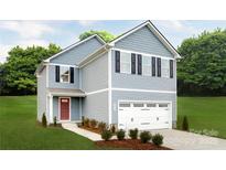 Charming two-story home with blue siding, attached garage and a well-manicured lawn at 120 Millstream Dr, China Grove, NC 28023