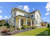 Charming two-story home boasts a welcoming front porch and beautifully landscaped front yard at 1507 Riverwalk Pkwy, Rock Hill, SC 29730