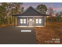 Charming single-story home with welcoming front porch and modern design elements at 15700 Stokes Ferry Rd, Richfield, NC 28137