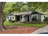 Charming home with a mix of materials, green lawn, mature trees, and traditional architecture at 20337 Nc Hwy 73 Hwy, Albemarle, NC 28001