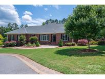 Charming brick home with a well-maintained lawn and mature landscaping at 216 Commodore Ct, Belmont, NC 28012
