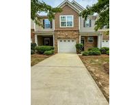 Charming townhome with a brick facade and a one-car garage at 2752 Sawbridge Ln, Gastonia, NC 28056