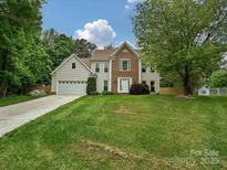 Charming two-story home with a well-manicured lawn and inviting front entrance at 3612 Woodnotch Ct, Charlotte, NC 28269