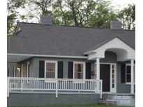 Charming single-story home with a cozy front porch and gray painted brick exterior at 406 S Catawba St, Lancaster, SC 29720