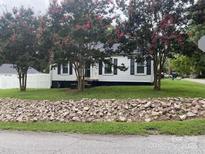 Charming single-story home with white siding, black shutters, and blooming crape myrtle trees at 507 Chrysler St, Kannapolis, NC 28083