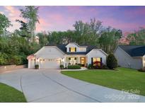 Charming home featuring a well-manicured lawn, two-car garage and a welcoming front porch at 5490 Sapwood Ct, Denver, NC 28037