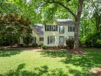 Charming two-story home with traditional architecture and lush front lawn surrounded by mature trees at 6100 Hunter Ln, Weddington, NC 28104
