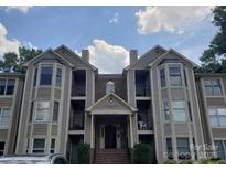 Inviting condo with a covered entrance, private balconies, and neutral siding providing an appealing exterior at 6234 Rosecroft Dr, Charlotte, NC 28215
