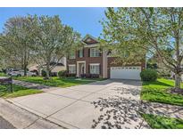 Charming two-story brick home with a well-manicured lawn and a spacious driveway at 639 Lorain Nw Ave, Concord, NC 28027