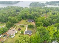 Picturesque aerial view of the property surrounded by lush trees, near a serene lake at 1215 Eastcreek Rd, Fort Lawn, SC 29714
