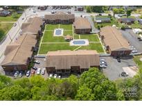This aerial view reveals the community's well-maintained lawn, swimming pool, ample parking, and convenient location at 123 Carriage House Dr, Kannapolis, NC 28081
