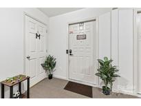 Welcoming entryway features neutral tones, sleek doors, and decorative plants adding a touch of greenery at 123 Carriage House Dr, Kannapolis, NC 28081