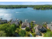 Stunning aerial view of lakefront homes with private docks on a sunny day at 3507 Governors Island Dr, Denver, NC 28037