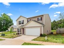 Two-story home with beige siding, white garage door, and red shutters sits under a blue sky at 355 Jared Steel Ln, Salisbury, NC 28146