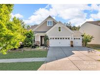 Charming two-story home with a three-car garage, manicured lawn, and stone accents for enhanced curb appeal at 5104 Samoa Ridge Dr, Lancaster, SC 29720