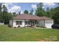 Charming single-story home featuring a well-maintained lawn, attached garage, and inviting front entrance at 5817 Wingate Hill Rd, Denver, NC 28037
