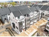 Modern townhome exteriors featuring a mix of white and gray siding with black trim at 6005 Countess Dr # 49, Charlotte, NC 28217