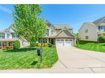Charming two-story home with a well-manicured lawn and a two-car garage at 924 Forbes Rd, Fort Mill, SC 29707