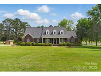 Stunning brick home featuring dormer windows, manicured lawn, and mature trees at 172 Fairway Cir, Rock Hill, SC 29730