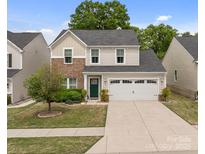 Charming two-story home featuring a well-manicured lawn, a two-car garage, and a welcoming front door at 176 Jennymarie Rd, Mooresville, NC 28115