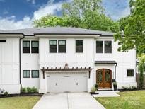 Charming two-story home with white brick, a wooden garage pergola, and a well-manicured lawn at 3505 Trent St, Charlotte, NC 28209