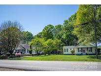 Charming street view of homes with lush lawns and mature trees on a sunny day at 495&501 Turnersburg Hwy, Statesville, NC 28625
