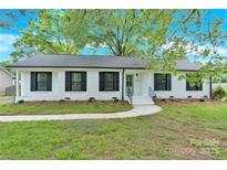 Charming single-story home with a landscaped front yard and a freshly-painted exterior at 6600 Knightswood Dr, Charlotte, NC 28226