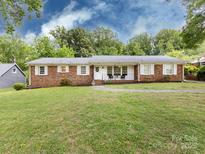 Charming brick ranch home with a well-manicured lawn and inviting front porch at 6616 Williams Rd, Charlotte, NC 28215